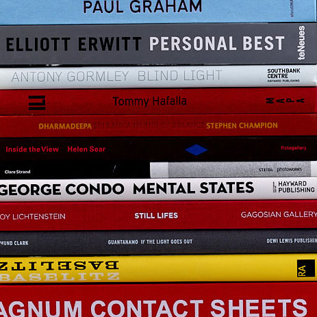 A stack of books designed by VIKA: Paul Graham, Elliot Erwitt, Anthony Gomley, Tommy Hafalla, Stephen Champion, Helen Sear, Clare Strand, George Condo, Roy Lichtenstein, Ed Clark, Georg Baselitz, Magnum Contact Sheets.