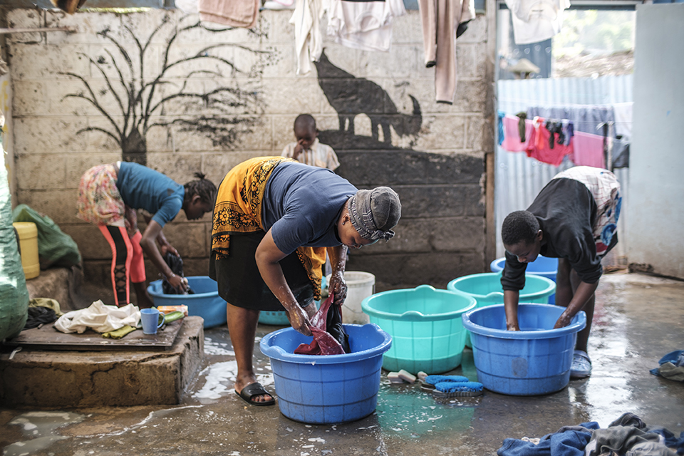 Women wash clothes at the Kibera Pride Children’s Home, in the city of Nairobi, Kenya, on October 27, 2023.