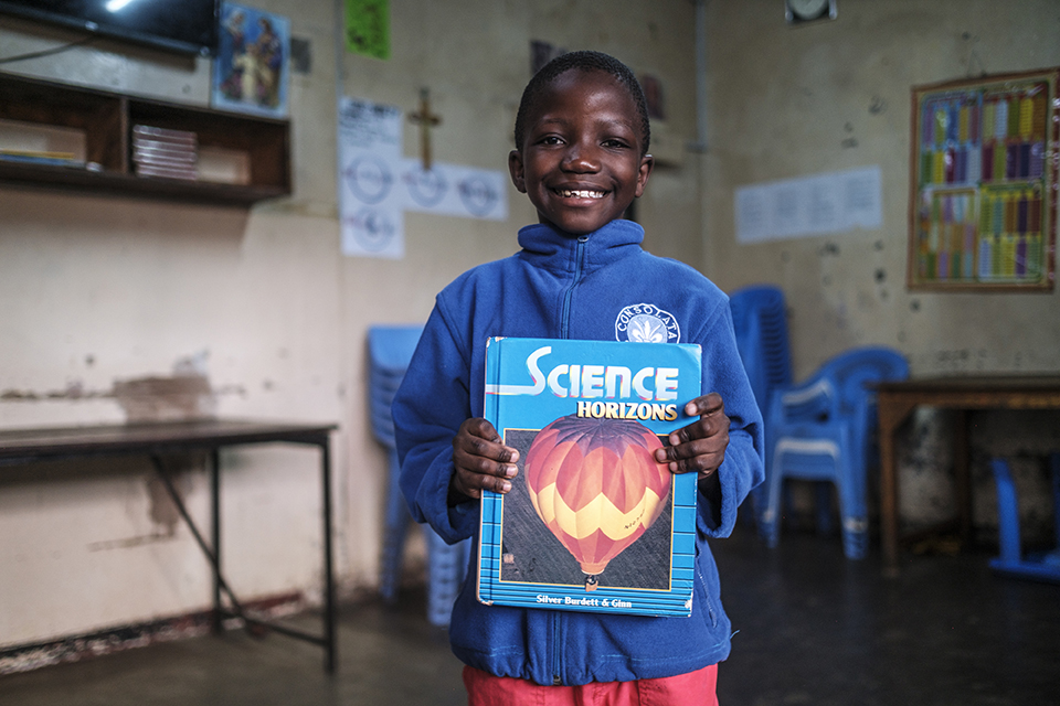 A child holds a book at the Kibera Pride Children’s Home, in the city of Nairobi, Kenya, on October 27, 2023.