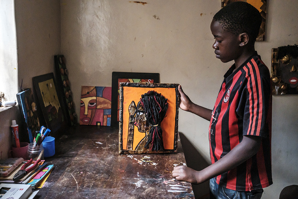 Martin Micheal holds a piece of art at the art workshop of the Kibera Pride Children’s Home, in the city of Nairobi, Kenya, on October 27, 2023.