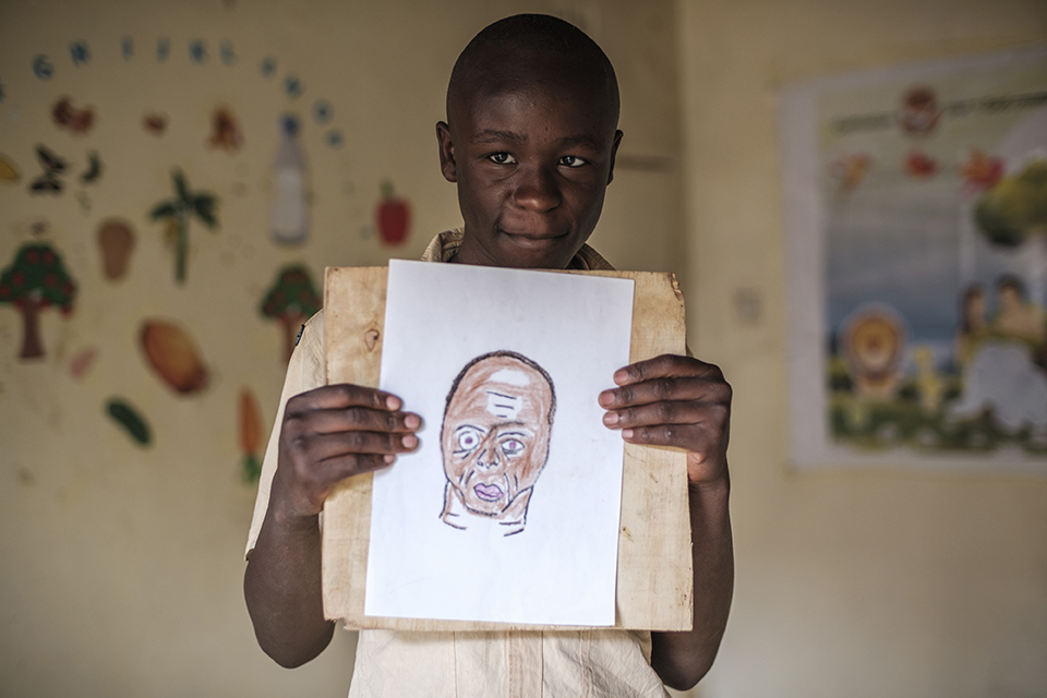 Jeremy Inyiende holds a piece of art at the Kibera Pride Children’s Home, in the city of Nairobi, Kenya, on October 27, 2023.