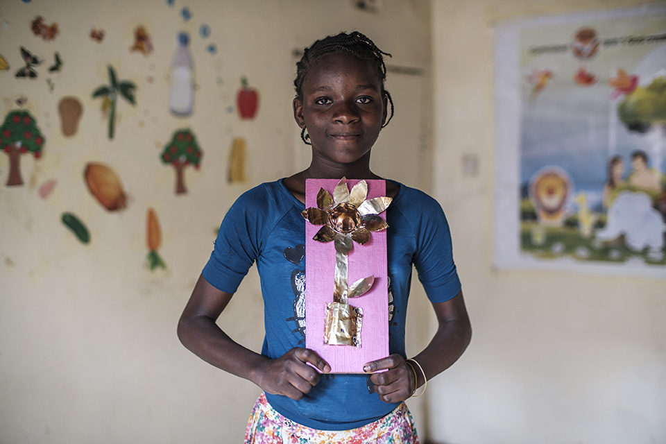 Banice Triza holds a piece of art at the Kibera Pride Children’s Home, in the city of Nairobi, Kenya, on October 27, 2023.