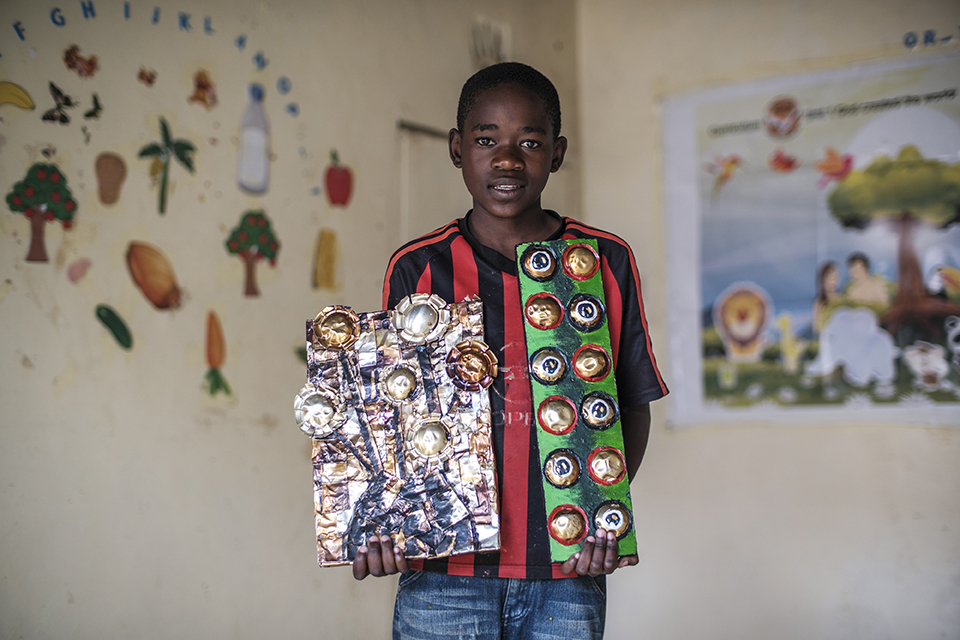 Martin Micheal holds a piece of art at the Kibera Pride Children’s Home, in the city of Nairobi, Kenya, on October 27, 2023.