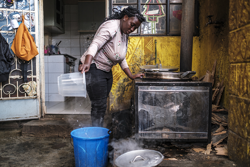 A woman pours hot water into a bin at the Kibera Pride Children’s Home, in the city of Nairobi, Kenya, on October 27, 2023.